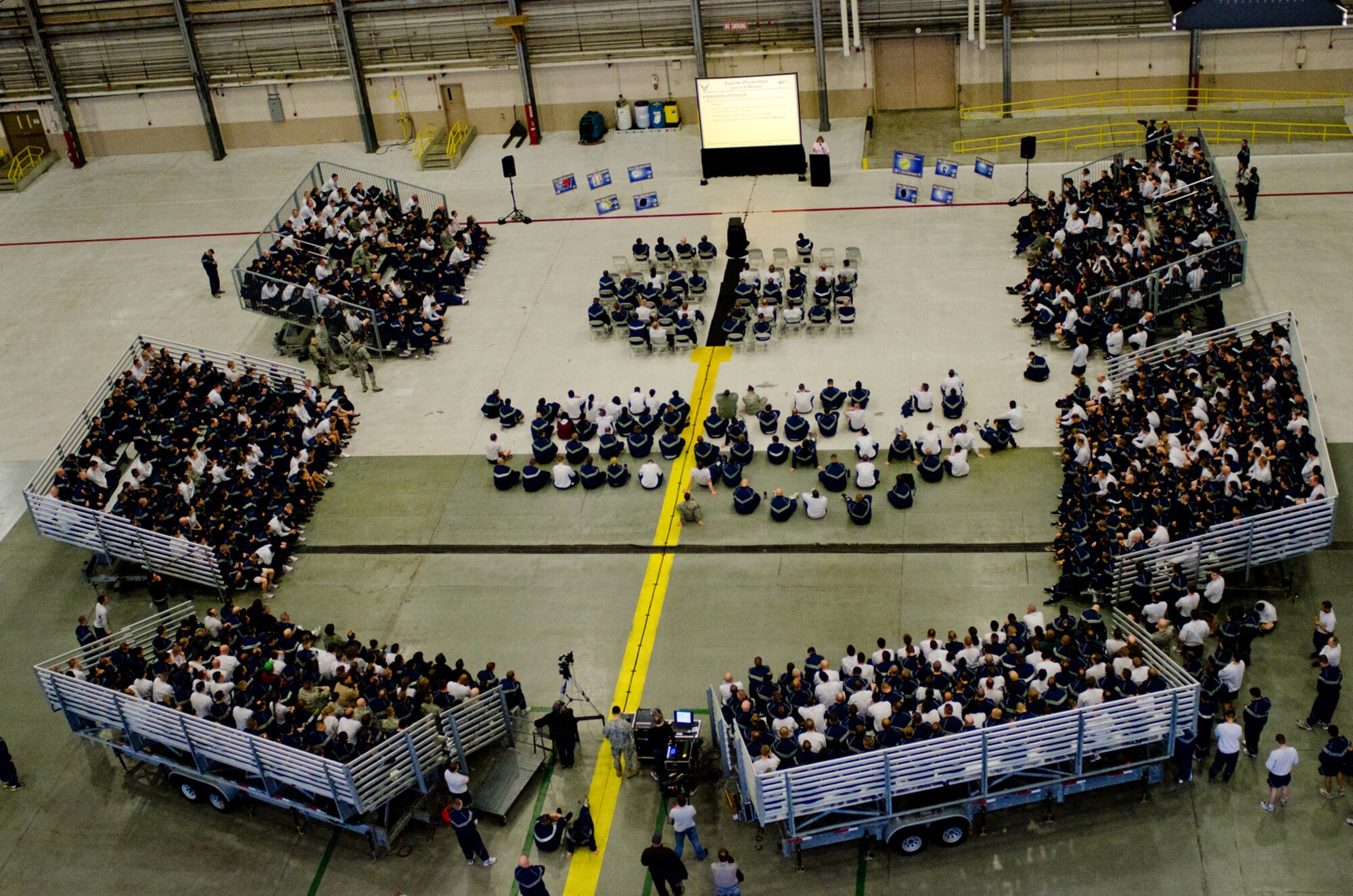 Airmen from across McChord Field watch a resilience video in Hangar 4 as part of Wingman Day, Dec. 2, 2011, at Joint Base Lewis-McChord, Wash. The resilience video was produced by McChord Airmen and featured characters dealing with adverse scenarios such as multiple deployments, financial and relationship problems, medication dependency and others. (U.S. Air Force photo/David Poe)