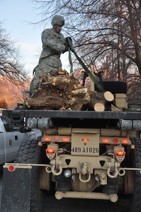 CENTERVILLE, Utah - A member of the Utah National Guard helps with clean-up efforts from a wind storm in Davis County, Utah on Dec. 4, 2011.  Utah Governor Gary Herbert activated approximately 200 members of the Guard to assist local authorities with the clean-up, and to prepare for an upcoming storm.  More than 25 heavy equipment vehicles were also dispatched to assist with the efforts. U.S. Army photo by 1LT Ryan Sutherland (RELEASED).