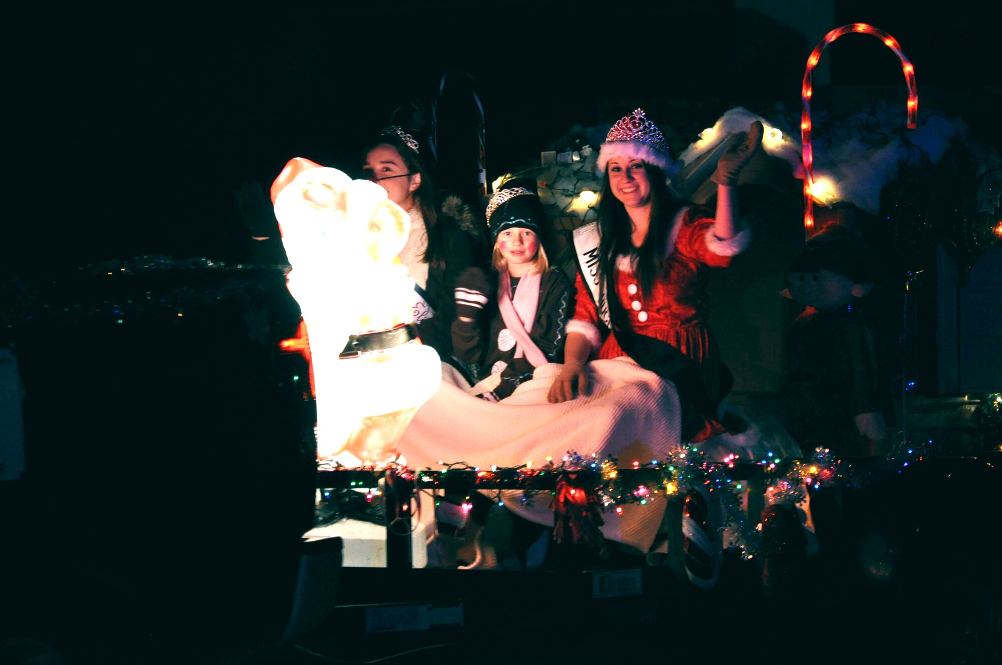 Float-goers wave to the crowd in the Rosamond Holiday Parade of Lights, Dec. 3. Members of Team Edwards judged around 30 parade floats submitted by private organizations and Rosamond businesses. (U.S. Air Force photo/Mike Strickler)