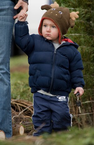 Easton Dailey, son of Senior Airman Anthony Dailey, stands with his mother, Ashlee Dailey, Dec. 2, 2011, on Nellis Air Force Base, Nev. More than 600 trees were donated to families of deployed spouses and Airmen from Nellis and Creech.  (U.S Air Force photo by Senior Airman Stephanie Rubi / Released)