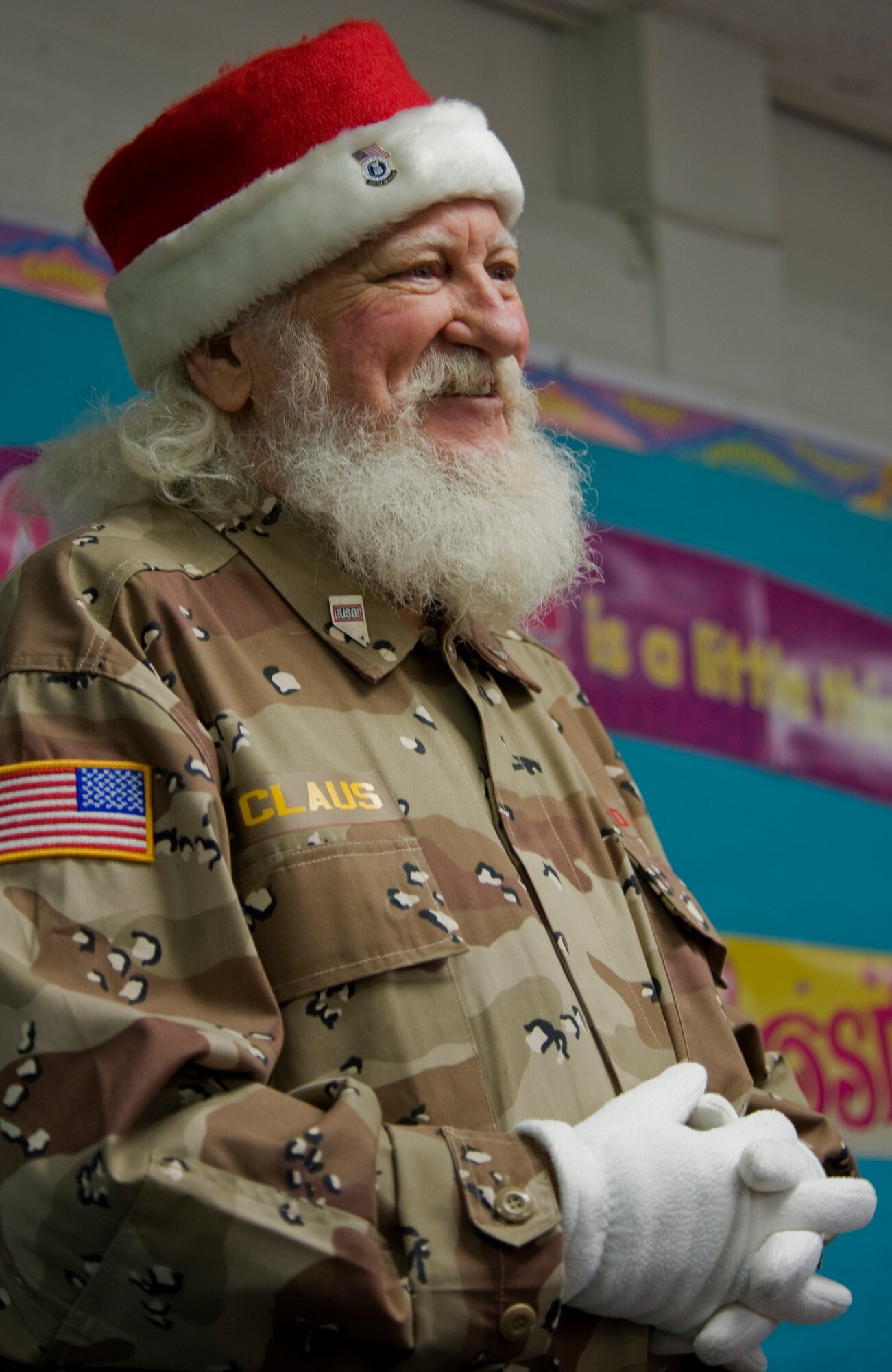 Bud Slade portrays Santa Claus Dec. 2, 2011, on Nellis Air Force Base, Nev. Blue Star Mothers and Santa Claus assisted students from Lomie Heard Elementary School as they stuffed stockings and created care packages for their deployed parents.  (U.S Air Force photo by Senior Airman Stephanie Rubi/Released)