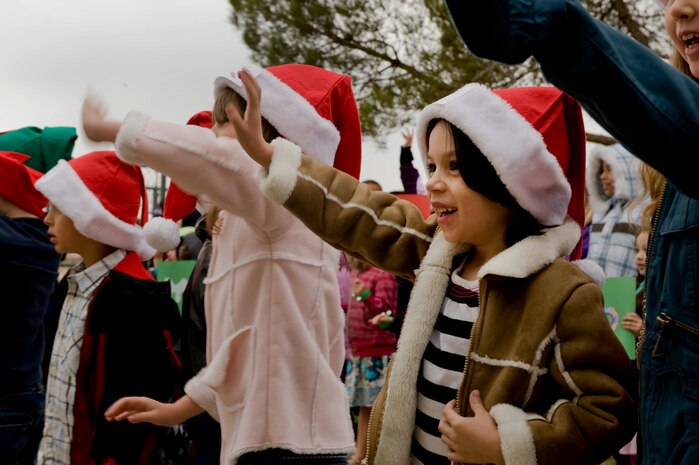 Students from Lomie Heard Elementary School wave to Santa as he arrives Dec. 2, 2011, on Nellis Air Force Base, Nev. Blue Star Mothers and Santa Claus assisted students from the school as they stuffed stockings and created care packages for their deployed parents.  (U.S Air Force photo by Senior Airman Stephanie Rubi/Released)
