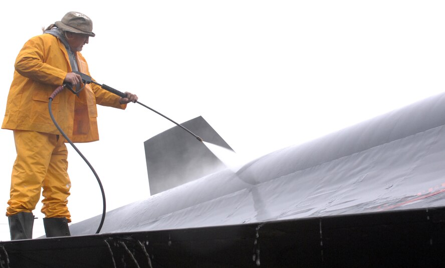 Donald Manning, North Florida Electrical Contractors Inc., power washes the top of a Lockheed SR-71A "Blackbird" on Barksdale Air Force Base, La., Dec. 6. Manning is part of a three-man team, cleaning and renovating the static display aircrafts on base. (U.S. Air Force photo/Airman 1st Class Joseph A. Pagan Jr.)(RELEASED)