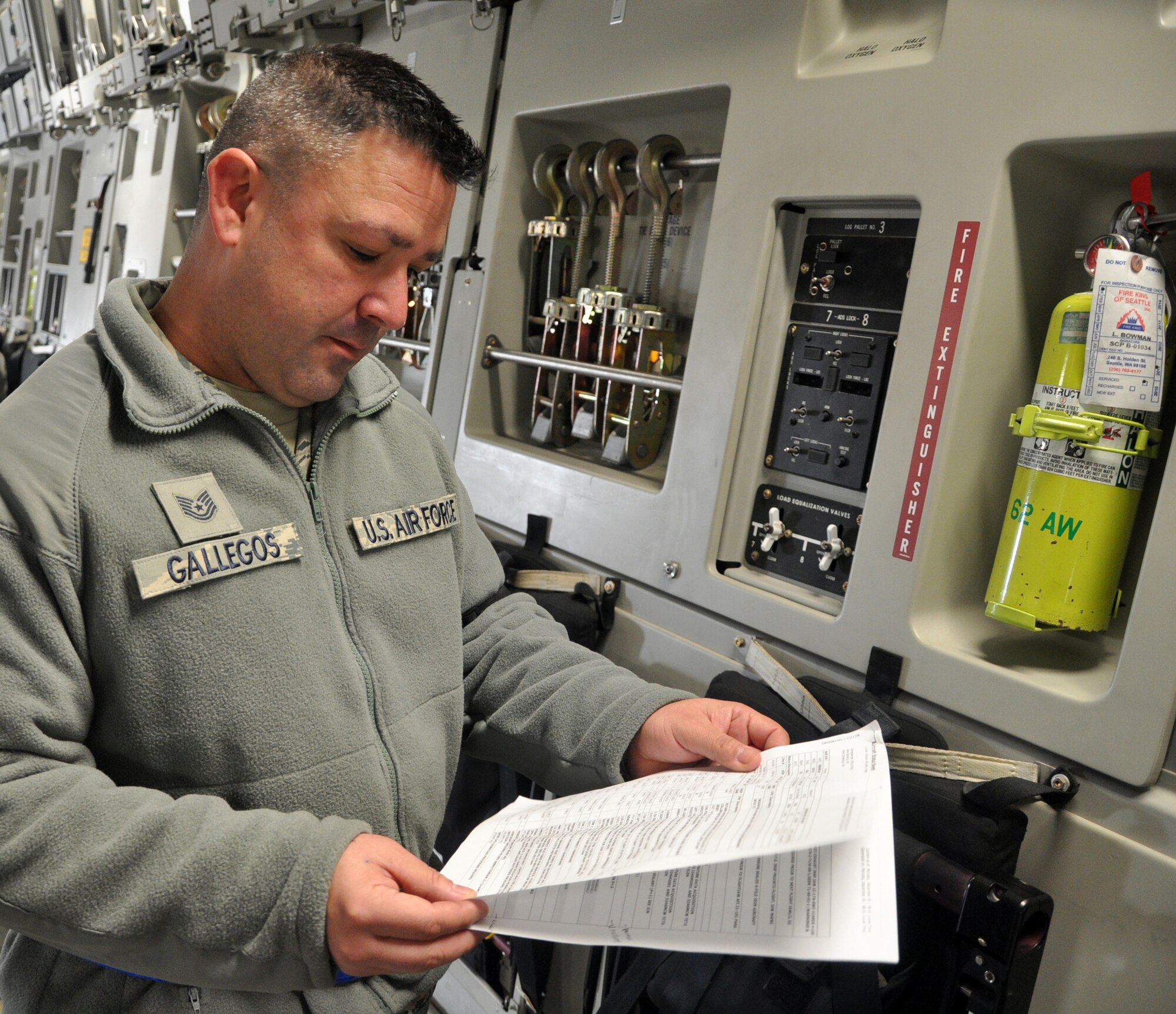 Tech. Sgt. David Gallegos, 446th Aircraft Maintenance Squadron crew chief here, reviews a maintenance plan for a C-17 Globemaster III at McChord Field Dec. 5.  Gallegos is leading a targeted maintenance team of Reservists who are conducting annual training and reducing delayed discrepancies, or non-grounding findings, for aircraft maintenance. (U.S. Air Force photo by Tech. Sgt. Elizabeth Moody)