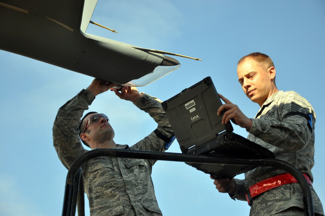 Senior Airman Michael Vickers, 446th Aircraft Maintenance Squadron guidance and control technician, left, and Tech. Sgt. Josh Vaught, 446th Maintenance Squadron crew chief here, replace an electrostatic discharger on a C-17 Globemaster III at McChord Field Dec. 5.  Vickers is a material expeditor at Hill Air Force Base, Utah in his civilian job and Vaught is a crew chief for the 62nd Maintenance Squadron here in his civilian job. (U.S. Air Force photo by Tech. Sgt. Elizabeth Moody)