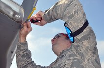 Senior Airman Michael Vickers, 446th Aircraft Maintenance Squadron guidance and control technician here, replaces an electrostatic discharger on a C-17 Globemaster III at McChord Field Dec. 5.  Vickers and other Reservists are part of a targeted maintenance team conducting annual training aimed at reducing delayed discrepancies for aircraft maintenance.  Vickers is a material expeditor at Hill Air Force Base, Utah in his civilian job. (U.S. Air Force photo by Tech. Sgt. Elizabeth Moody)