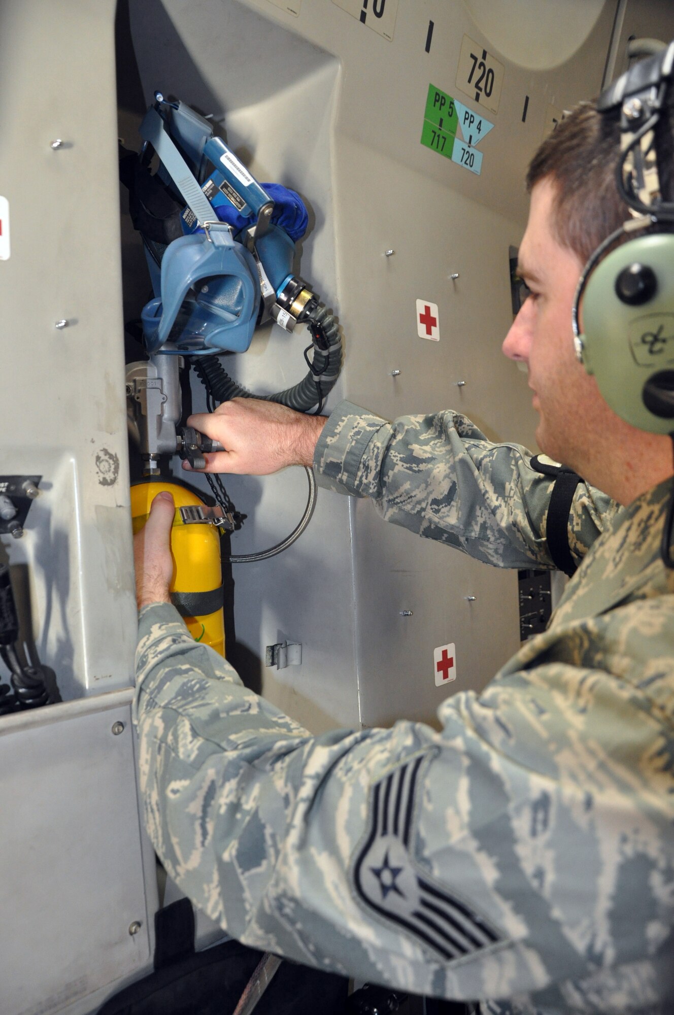 Staff Sgt. Tom Hathaway, 446th Aircraft Maintenance Squadron crew chief here, inspects an oxygen bottle aboard a C-17 Globemaster III at McChord Field Dec. 4.  Hathaway is part of a targeted maintenance team of Reservists conducting annual training aimed at reducing delayed discrepancies, or non-grounding findings, for aircraft maintenance.  (U.S. Air Force photo by Tech. Sgt. Elizabeth Moody)