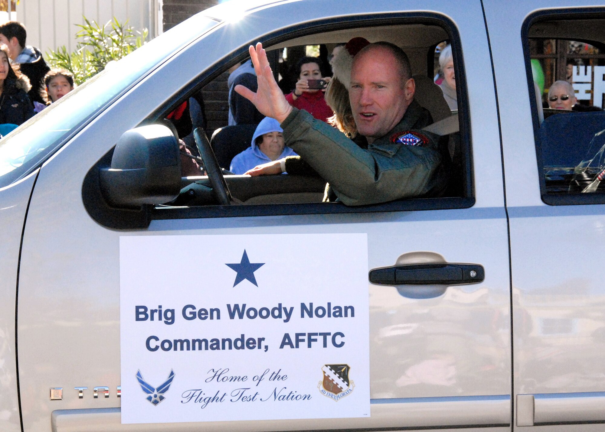 Brig. Gen. Robert C. Nolan II, Air Force Flight Test Center commander, wishes Lancaster Boulevard 'Happy Holidays' in the Lancaster Christmas Parade, Dec. 3. Nolan was invited to represent the Air Force Flight Test Center and Edwards AFB in the parade hosted by the Antelope Valley Chamber of Commerce Lancaster and Rosamond. (U.S. Air Force photo/Gary Hatch)