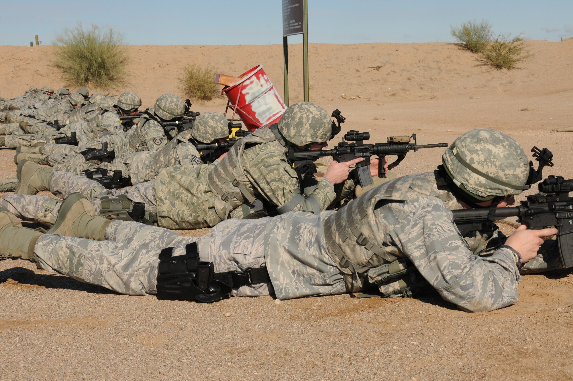 Members of the 161st Security Forces Squadron participate in weapons qualification Dec. 5, 2011, at the National Guard training range in Florence, Ariz. Beginning Dec. 1, 2011, all Airmen are required to qualify in a new rifle course which is designed to train personnel on safety, operator maintenance, weapon operation and handling skills, basic marksmanship fundamentals, tactical movement, use of cover, threat engagement techniques, threat discrimination and night threat engagement. (U.S. Air Force photo/Tech. Sgt. Susan Gladstein)