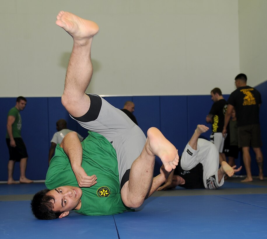 Staff Sgt. David Guba, a mixed military combatives instructor, demonstrates maneuvers during a Mixed Military Combatives class at Langley Air Force Base, Va., Dec. 6, 2011. Based on the Modern Army Combatives Program, the program is designed to arm Airmen with the skills to protect themselves in case they are unarmed and in close combat with an enemy. (U.S. Air Force photo by Staff Sgt. Antoinette Gibson/Released)