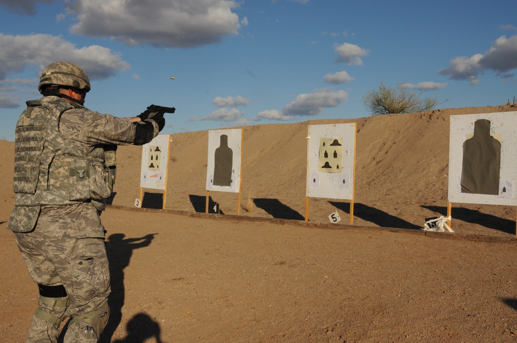 Capt. David Foulke, 161st Security Forces Squadron commander, practices transitioning to the handgun during weapons qualification Dec. 5, 2011, at the National Guard training range in Florence, Ariz. Beginning Dec. 1, 2011, all Airmen are required to perform in the modernized rifle qualification course which comprises movement while engaging targets to better train and equip Airmen. (U.S. Air Force photo/Tech. Sgt. Susan Gladstein)