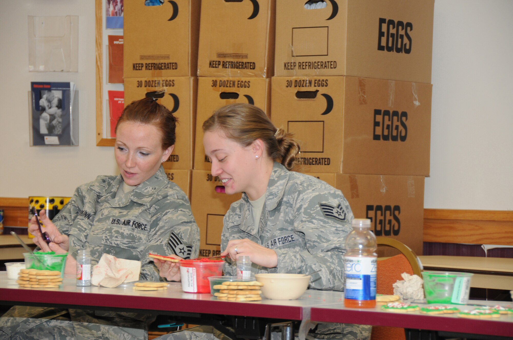 SSgt Kelly Dunn and SSgt Kara Schmidt, 107th Airlift Wing pick their favorite Christmas songs while working the OPERATION CHRISTMAS COOKIE. (Air Force Photo/SMSgt Ray Lloyd)