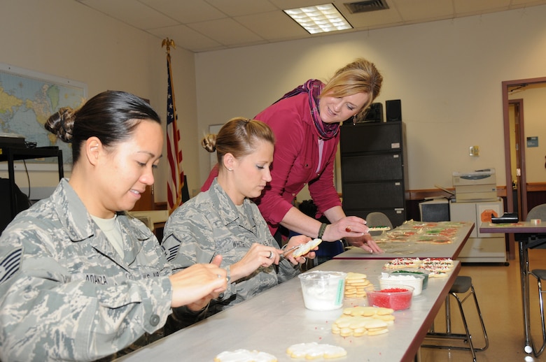 TSgt Aliza Adanza, MSgt Chanda White and Jeanne Goetze work the OPERATION CHRISTMAS COOKIE production line.(Air Force Photo/SMSgt Ray Lloyd)