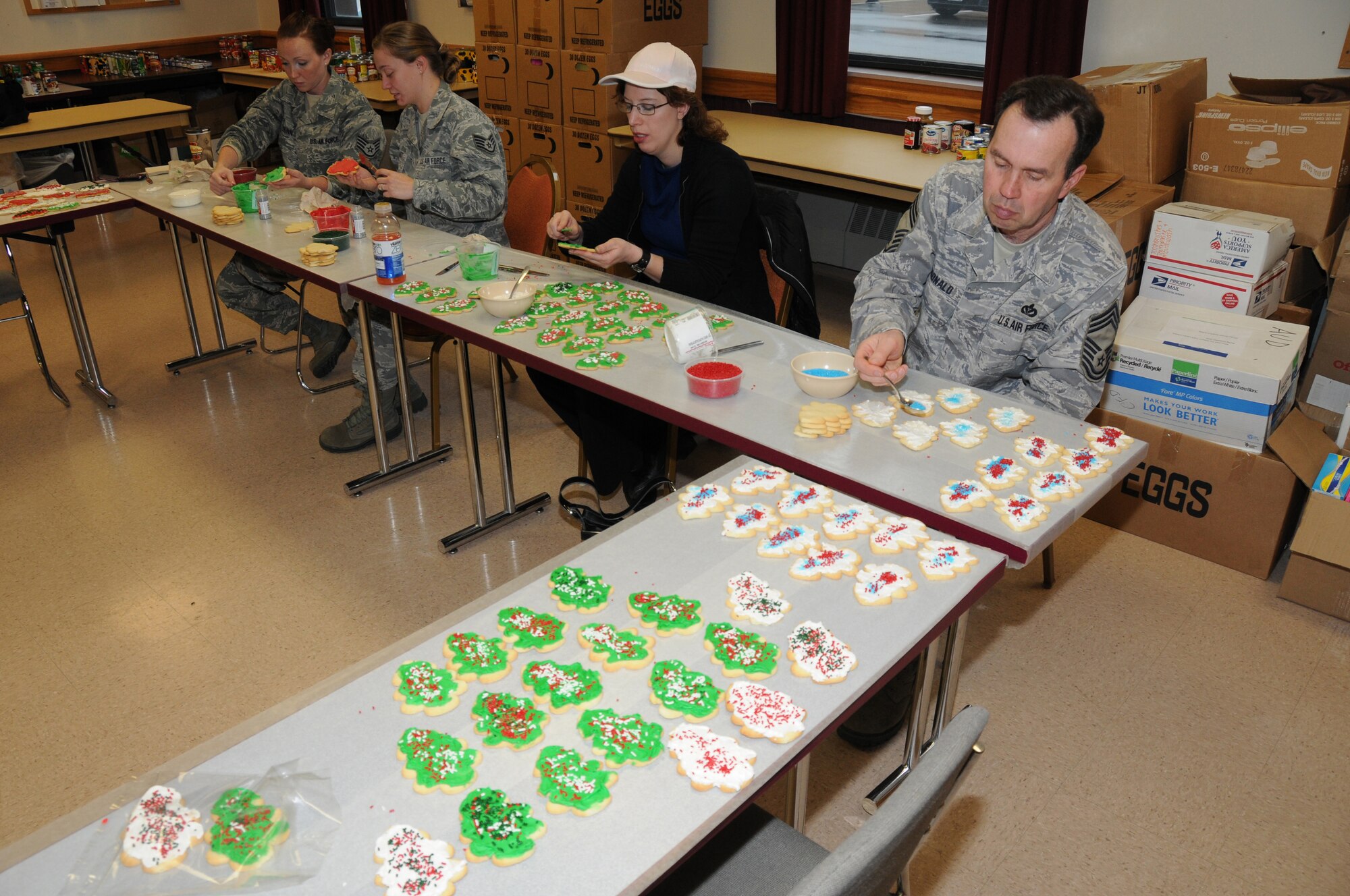 SSgt Kelly Dunn, SSgt Kara Schmidt, Karin Zimmerman and CMSgt Earl McDonald. All from the  107TH Airlift Wing, Decorate cookies during the wing's first OPERATION CHRISTMAS COOKIE. (Air Force Photo/SMSgt Ray Lloyd)
