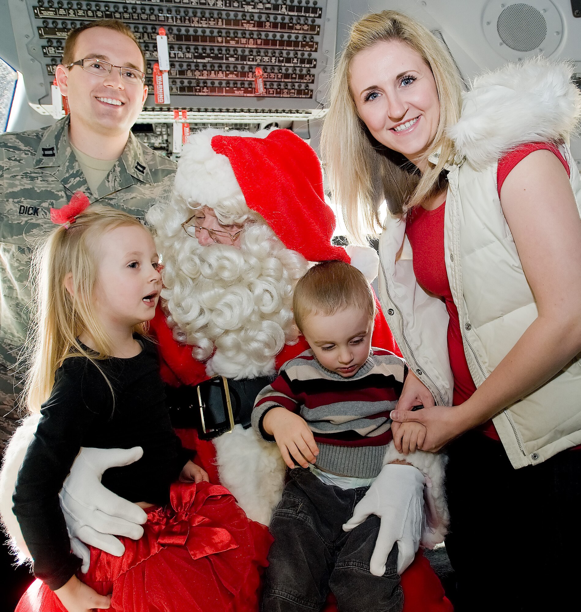 Capt. William Dick, 436th Medical Squadron, his daughter Jane, his son Beckham, and wife Mary, visit Santa Claus on a C-17 Dec. 4, 2011, at Dover Air Force Base, Del. Hundreds of Team Dover members took advantage of the opportunity to share Christmas wishes with Santa. (U.S. Air Force photo by Airman 1st Class Samuel Taylor)