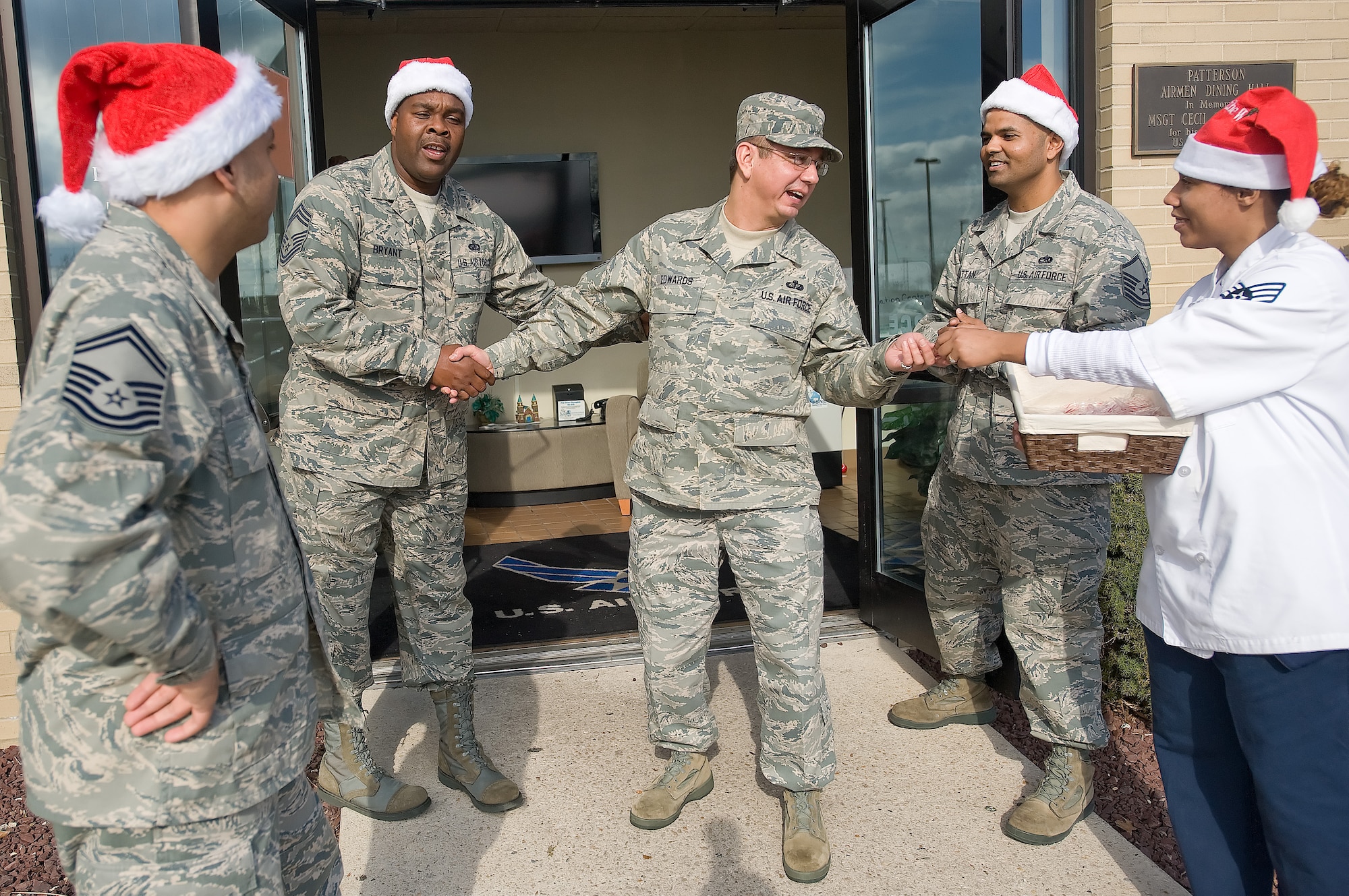 Candy canes and handshakes are given out Dec. 4, 2011, at the Dover Air Force Base, Del., dining facility. Dozens of Team Dover members volunteered time at the DFAC to share the holiday spirit. (U.S. Air Force photo by Airman 1st Class Samuel Taylor)