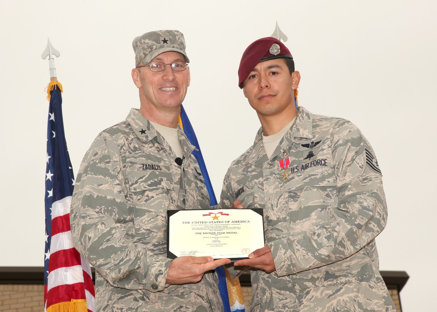 Brig. Gen. Timothy Zadalis, Air Education and Training Command Intelligence, Operations and Nuclear Integration director from Randolph AFB awards Tech. Sgt. Luis Garcia, 342nd Training Squadron pararescueman, with a Bronze Star Medal with Valor during an award ceremony at Lackland Air Force Base, Texas, Dec. 2. Only 414 Bronze Star Medals with Valor have been awarded to Air Force service members since Sept. 11, 2001. (U.S. Air Force photo/Robbin Cresswell)