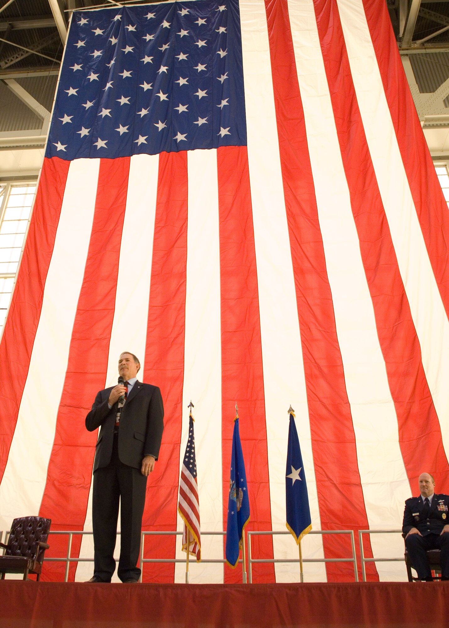 Thomas Berard, executive director, Air Force Flight Test Center, speaks to his family, friends and colleagues during his retirement ceremony, Dec. 2, in Hangar 1600. Berard ended his 33 year career of government service as the AFFTC’s senior-most civilian in senior executive service. (U.S. Air Force photo/Edward Cannon)