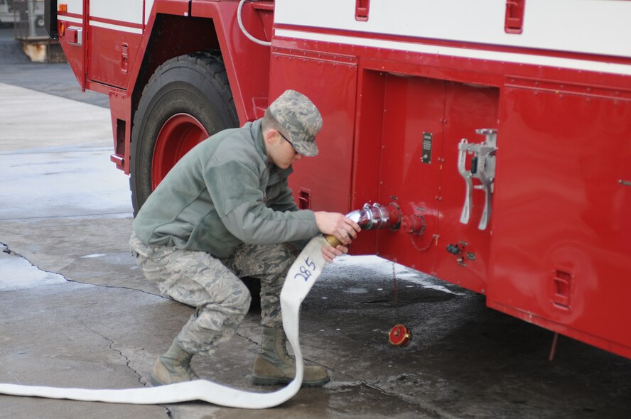 Staff Sgt. Michael Beller works on a fire engine at the 162FW fire station. (U.S. Air Force photo/Airman 1st Class Jackson Hurd)