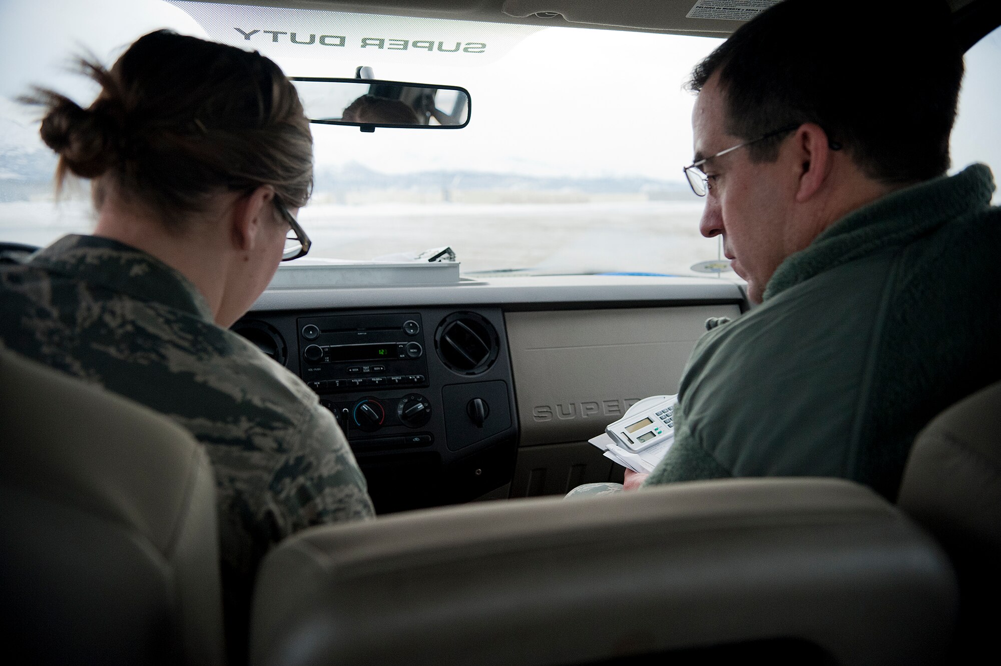 Airman 1st Class Aubrey Gregoire, 3rd Operations Support Squadron airfield management operations coordinator and Chief Master Sgt. Steven Bohannon, 3rd Wing command chief, prepare to perform a runway condition reading on the flight line Nov. 30, 2011. These readings are used in calculations to make sure that aircraft can land safely.  (U.S. Air Force photo/Staff Sgt. Zachary Wolf)
