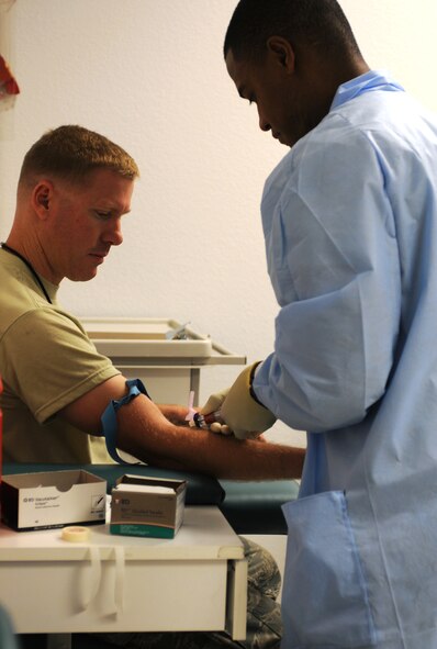 A medical technician draws the blood of a 162nd Fighter Wing patient during the December Unit Training Assembly. (U.S. Air Force photo/1st Lt. Angela Walz)