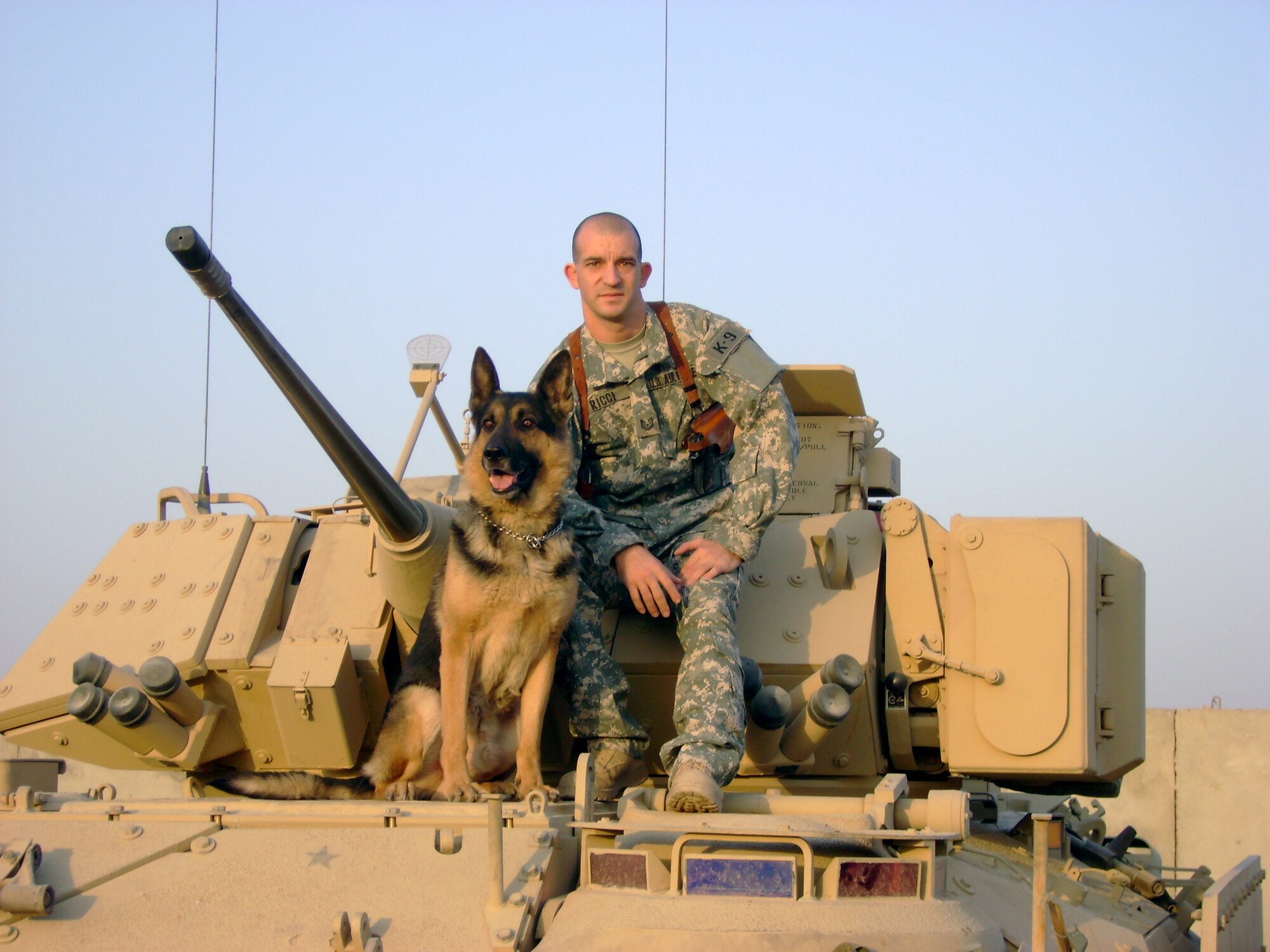 Tech. Sgt. John Ricci, 50th Security Forces Squadron, Schriever, AFB, Colo., and Eddy, a German Shepherd, get a picture together during their deployment to Iraq in 2007. Beginning in 2003, Eddy endured five deployments to Kuwait and Iraq. (Courtesy photo)