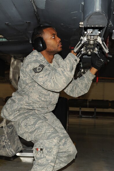 Staff Sgt. Donald Williams, 4th Aircraft Maintenance Squadron armament weapons journeyman, performs a visual check on an F-15E Strike Eagle during a minimum proficiency requirement load refresher on Seymour Johnson Air Force Base, N.C., Nov. 30, 2011. Load crew teams consist of three positions: one-man, two-man and three-man. Williams is the one-man of his load crew team. The one-man supervises the load and checks behind the Airmen to make sure everything was done properly. Williams is from Los Angeles. (U.S. Air Force photo by Senior Airman Whitney Stanfield)