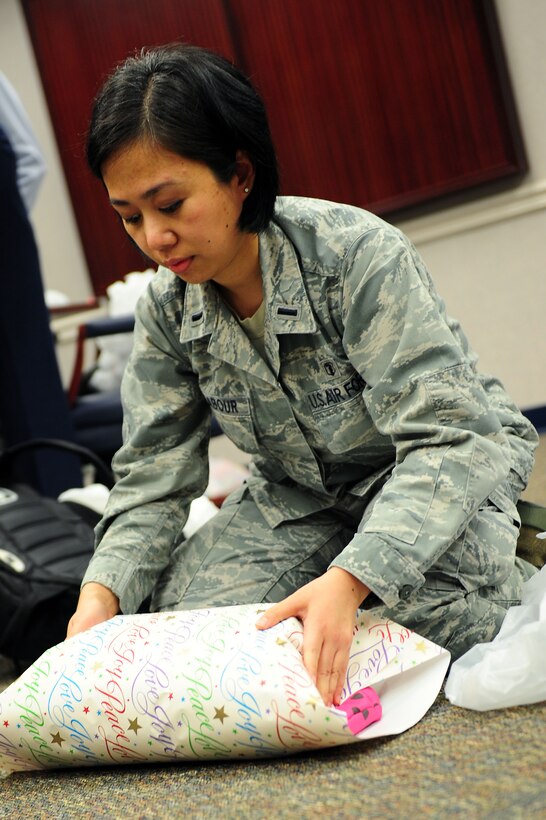 U.S. Air Force 1st Lt. Maira Malhabour, 633rd Medical Support Squadron laboratory services element chief, wraps a gift for during the Angel Tree Wrapping party at Langley Air Force Base, Va., Dec. 5, 2011. The annual Angel Tree program lets individuals choose a tag containing an underprivileged child’s wish list and buy that child presents for the holidays.  (U.S. Air Force photo by Airman 1st Class Kayla Newman/Released) 