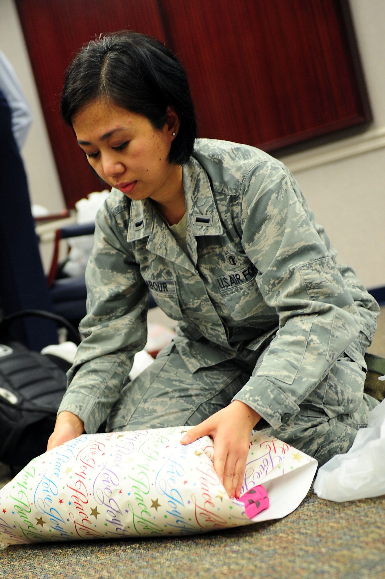 U.S. Air Force 1st Lt. Maira Malhabour, 633rd Medical Support Squadron laboratory services element chief, wraps a gift for during the Angel Tree Wrapping party at Langley Air Force Base, Va., Dec. 5, 2011. The annual Angel Tree program lets individuals choose a tag containing an underprivileged child’s wish list and buy that child presents for the holidays.  (U.S. Air Force photo by Airman 1st Class Kayla Newman/Released) 