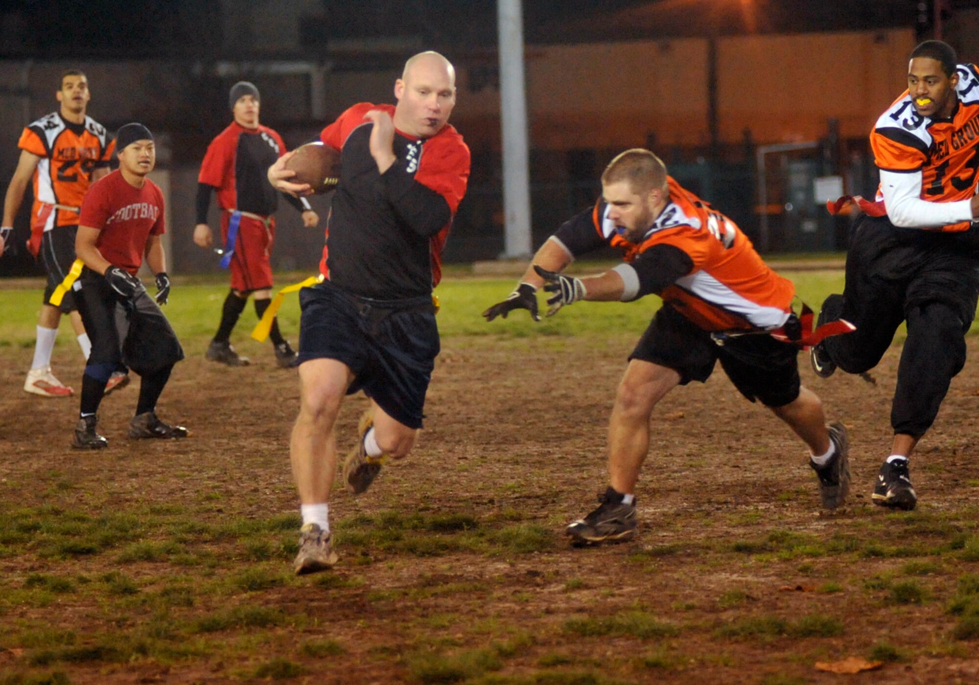 Brian Lawrence of the 436th Civil Engineer Squadron runs for a first down while 436th Med Group defenders attempt to pull his flag on Dec. 1, 2011 at Dover Air Force Base, Del. The Med Group defeated CE 34-27 and 25-18 to win the base championship. (U.S. Air Force photo by Tech. Sgt. Chuck Walker)