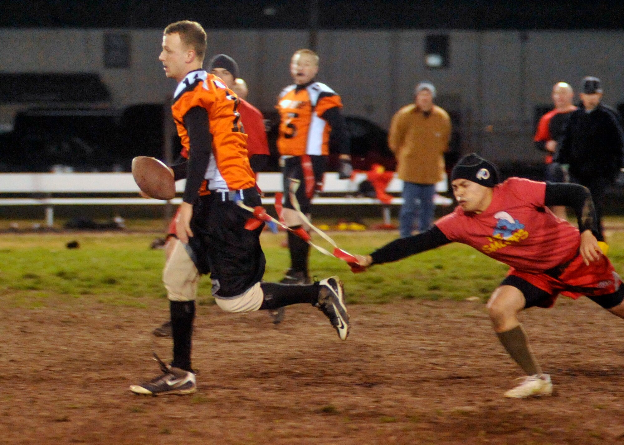 436th Med Group quarterback/coach Ian Money runs for a first down while a 436 Civil Engineer Squadron defender pulls his flag during the base flag-football championship on Dec. 1, 2011 at Dover Air Force Base, Del. The Med Group defeated CE 34-27 and 25-18 to win the championship. (U.S. Air Force photo by Tech. Sgt. Chuck Walker)