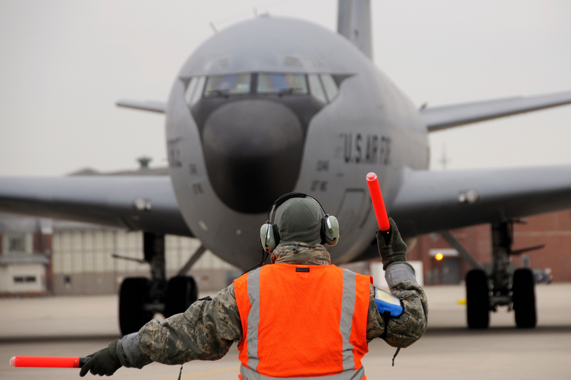 A crew chief with the 191st Aircraft Maintenance Squadron marshals a KC-135 Stratotanker aircraft toward the runway prior to a mission at Selfridge Air National Guard Base, Mich., Dec. 3, 2011. Crew chiefs perform and coordinate a wide variety of maintenance tasks and prepare the aircraft for flight. (U.S. Air Force photo by TSgt. David Kujawa)