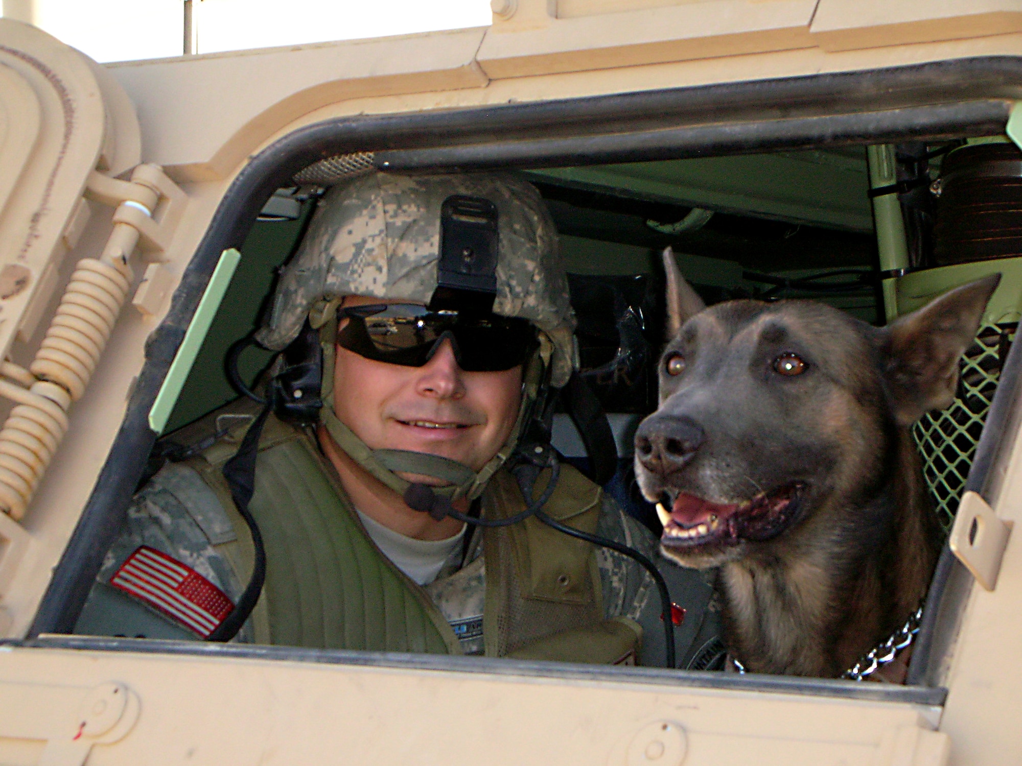 Master Sgt. Craig Young, former 95th Security Forces Squadron, and his then military working dog, Telin, take a break from a patrol while on deployment to Iraq in 2007 and 2008. Telin, a Belgian Malinois and former military working dog at Edwards, deployed three times during his military career. (Courtesy photo)