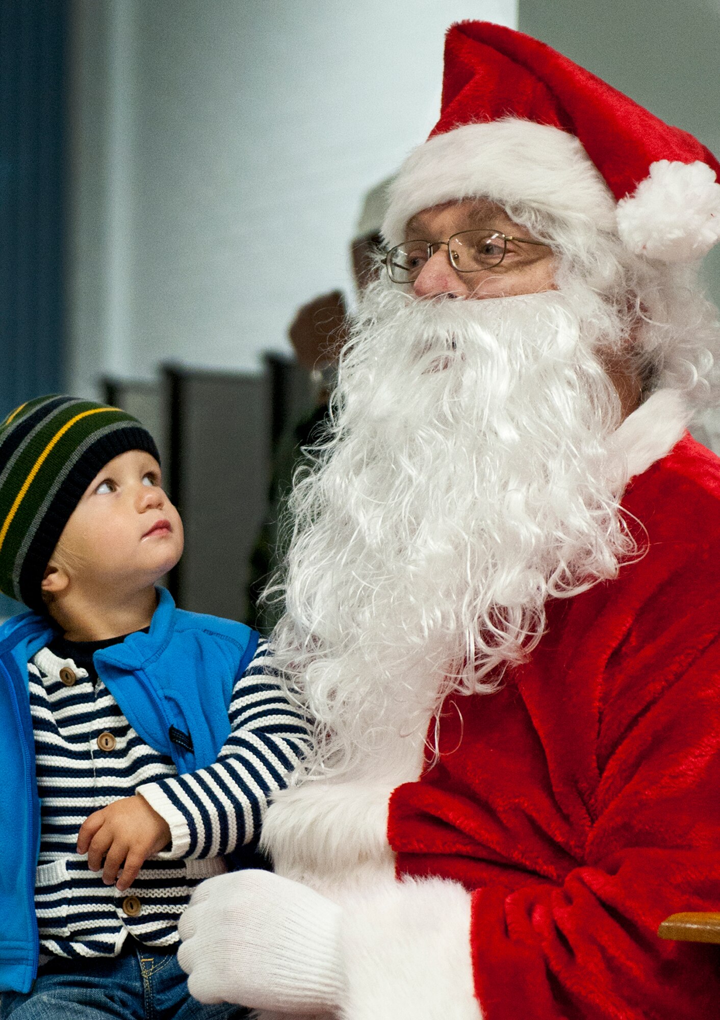 Santa vists with a child at the West Gate chapel Dec. 2 after the official tree lighting ceremony at Eglin Air Force Base, Fla. The ceremony included carols sung by Eglin Elementary students and the announcement of the Christmas card contest winners. (U.S. Air Force photo/Sachel Seabrook)