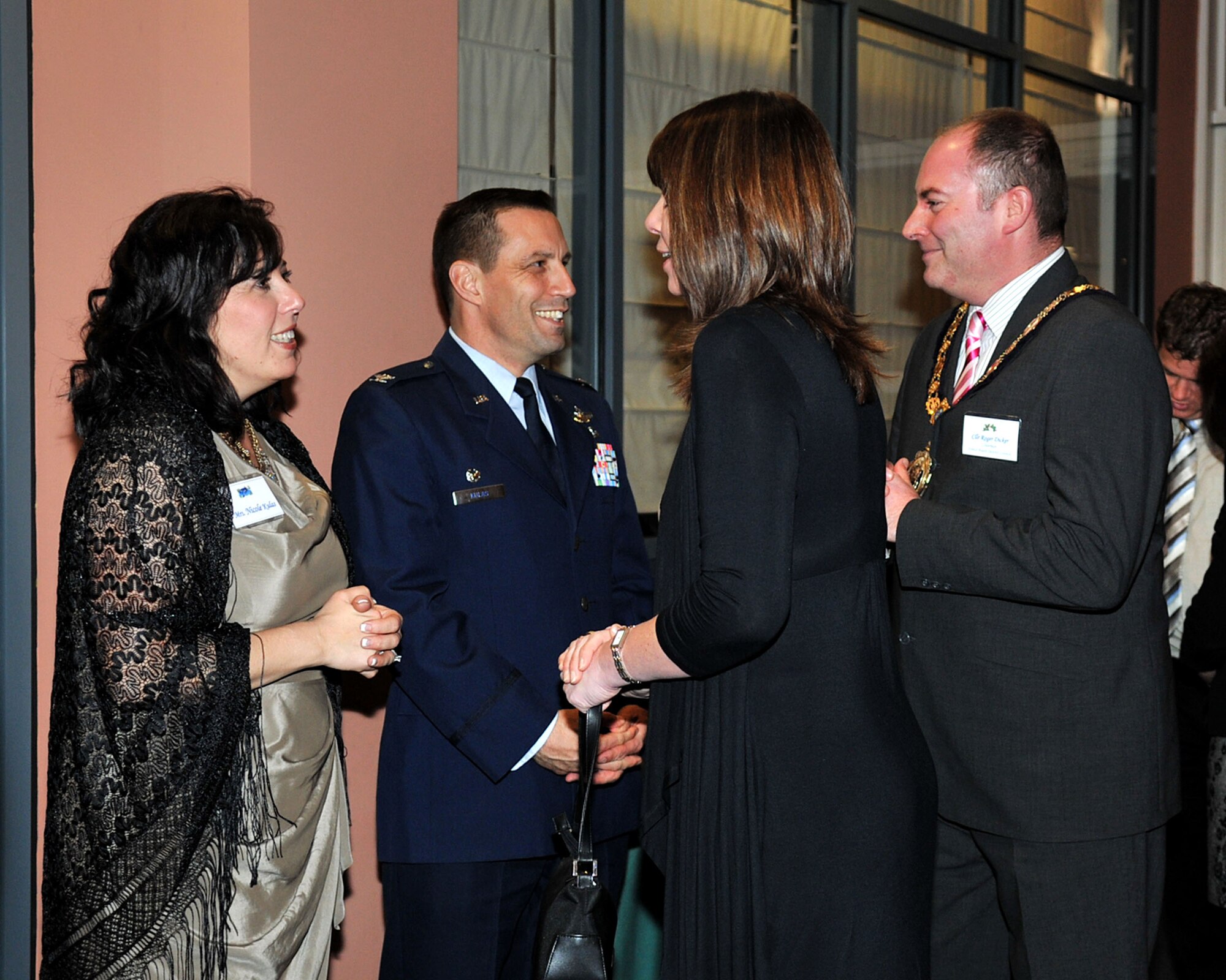 RAF MILDENHALL, England – Col. Christopher Kulas, 100th Air Refueling Wing commander, and his wife, Nicole, (left) greet Councillor Roger Dicker, Chairman of Forest Heath District Council, and his wife, Dawn, during the RAF Mildenhall and RAF Lakenheath 2011 Yuletide Reception at the Galaxy Club here Dec. 2, 2011. Leadership from RAF Mildenhall and RAF Lakenheath welcomed community leaders for a social gathering to celebrate the holiday season. (U.S. Air Force photo/Senior Airman Jerilyn Quintanilla) 