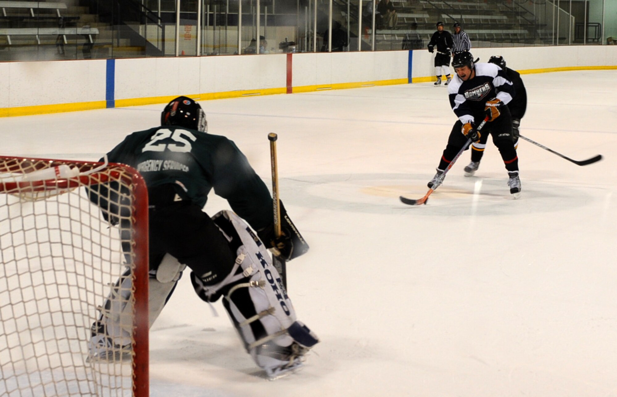 Ellsworth Bombers Division C team member Master Sgt. Alan Malone, 28th Logistics Readiness Squadron vechicle operations supervisor, lines up a shot after a break against the opposing team’s goalie at the Roosevelt Ice Park Arena in Rapid City, S.D., Nov. 22, 2011. The Ellsworth Bombers which includes more than 27 Air Force Airman from Ellsworth, are wrapping up the current season. (U.S. Air Force photo by Airman 1st Class Zachary Hada/Released)