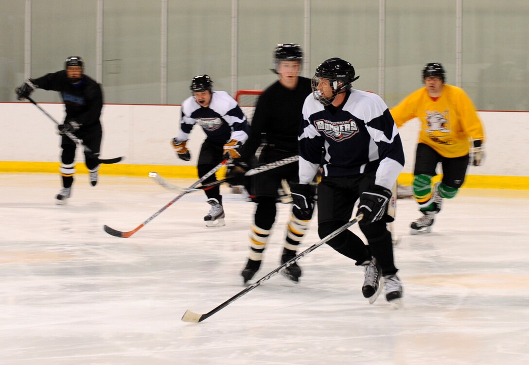 Lt. Col. Christopher Clark, 432nd Attack Squadron commander, from the Ellsworth Bombers skates down the ice at the Roosevelt Ice Park Arena in Rapid City, S.D., Nov. 22, 2011. The Ellsworth Bombers Division C hockey team consists of many Air Force members of various skills and career fields. (U.S. Air Force photo by Airman 1st Class Zachary Hada/Released)