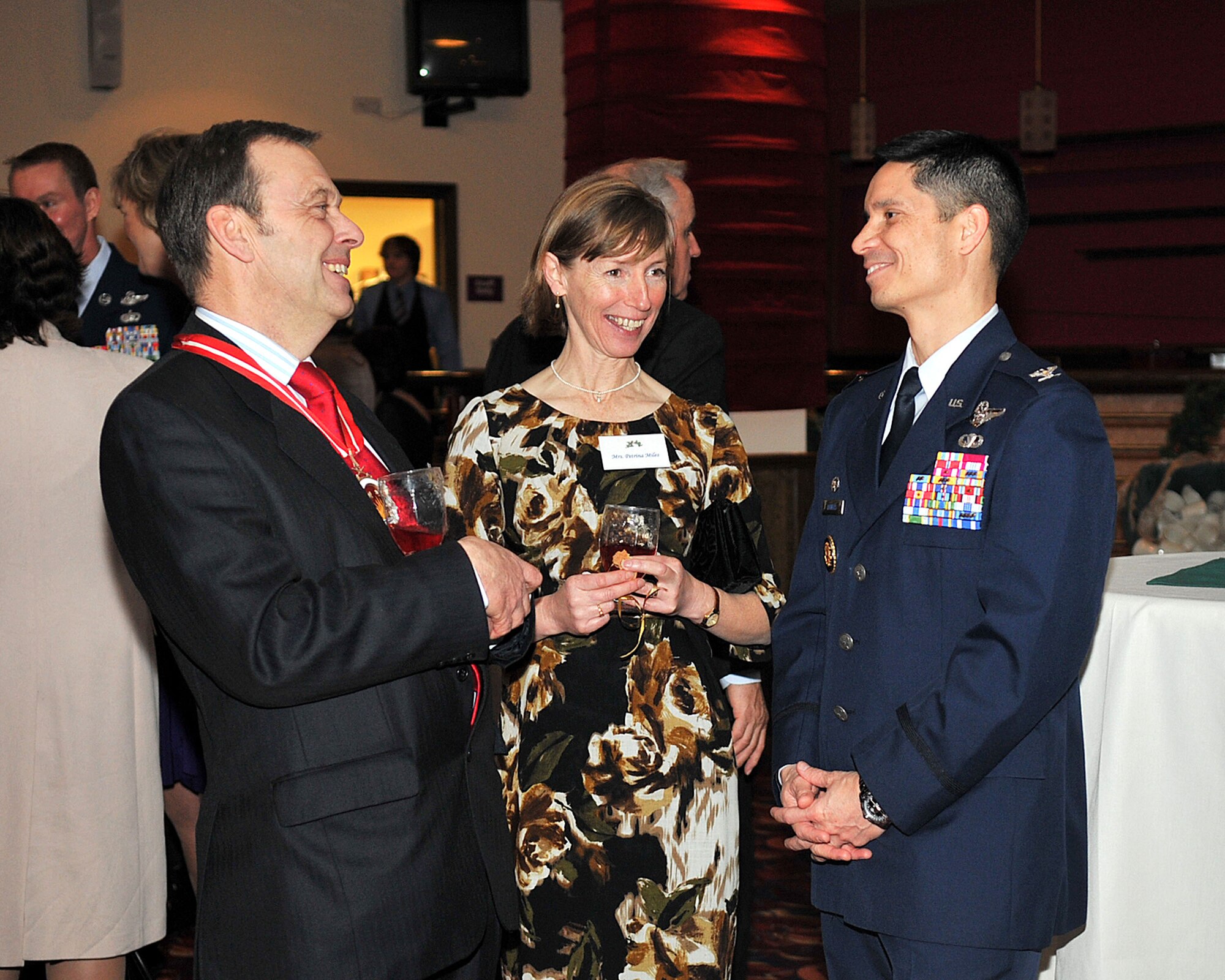 RAF MILDENHALL, England – Stephen Miles, (left) High Sheriff of Suffolk, his wife, Petrina and Col. John Quintas, 48th Fighter Wing commander, attended the RAF Mildenhall and RAF Lakenheath 2011 Yuletide Reception at the Galaxy Club here Dec. 2, 2011. Col. Christopher Kulas, 100th Air Refueling Wing commander, and Quintas welcomed local community leaders for a special social to kick off the holiday season. (U.S. Air Force photo/Senior Airman Jerilyn Quintanilla)