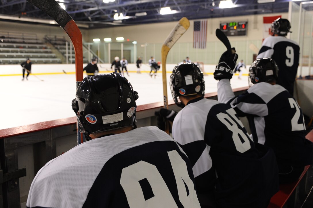 Members of the Ellsworth Bombers Division C team cheer on their teammates during a game against the Guiness Division C team at the Roosevelt Ice Park Arena in Rapid City, S.D., Nov. 22, 2011. Players are able to rotate on and off the ice when a player is within 5 to 10 feet of the bench while the puck is still in play. (U.S. Air Force photo by Airman 1st Class Zachary Hada/Released)