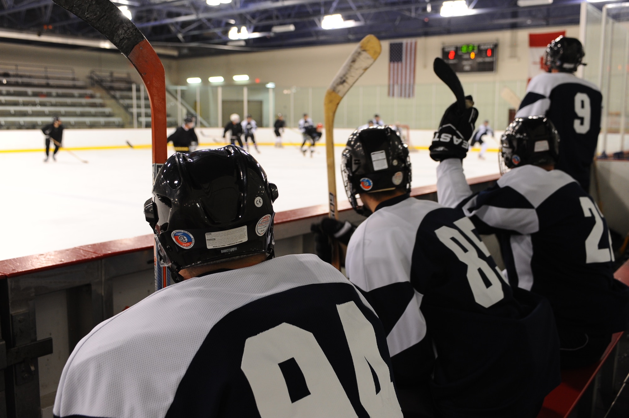 Members of the Ellsworth Bombers Division C team cheer on their teammates during a game against the Guiness Division C team at the Roosevelt Ice Park Arena in Rapid City, S.D., Nov. 22, 2011. Players are able to rotate on and off the ice when a player is within 5 to 10 feet of the bench while the puck is still in play. (U.S. Air Force photo by Airman 1st Class Zachary Hada/Released)