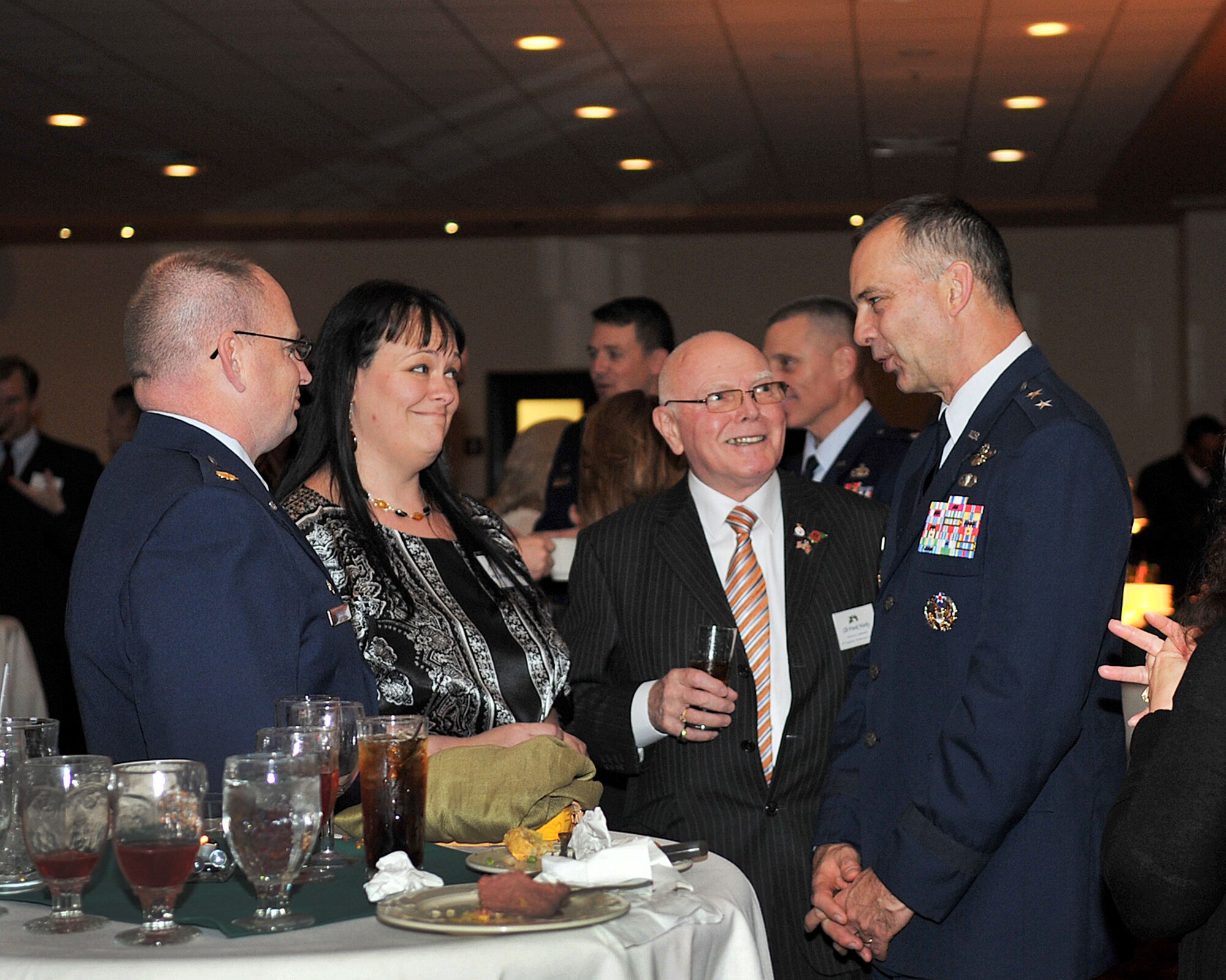 RAF MILDENHALL, England – (From Left) Maj. Anthony Deguchi, 48th Equipment Maintenance Squadron commander, his wife, Annette, Councillor Frank Warby, 48th EMS Honorary commander, and Maj. Gen. Mark Zamzow, 3rd Air Force vice commander, attended the RAF Mildenhall and RAF Lakenheath 2011 Yuletide Reception at the Galaxy Club here Dec. 2, 2011. Leadership from RAF Mildenhall and RAF Lakenheath welcomed community leaders for a social gathering to celebrate the holiday season. (U.S. Air Force photo/Senior Airman Jerilyn Quintanilla)