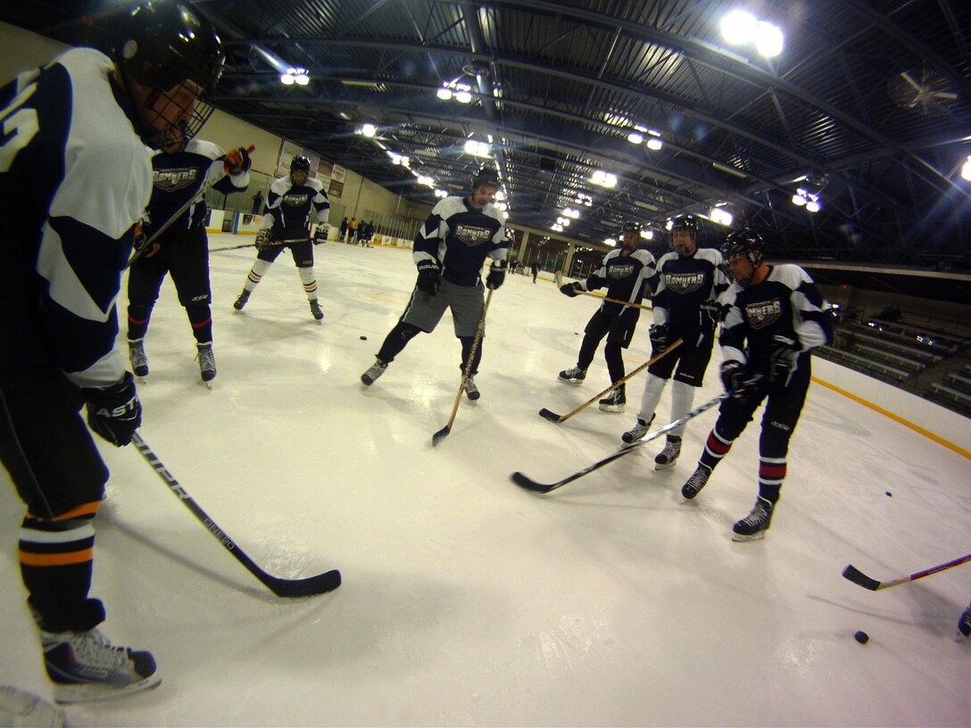 The Ellsworth Bombers Division C hockey team gathers on the ice during warm up exercises before a game at the Roosevelt Ice Park Arena in Rapid City, S.D., Nov. 22, 2011. Ellsworth Airmen interested in joining the team and improving their skills on the ice can contact the team manager, Maj. Shawn Bock, 37th Bomb Squadron assistant director of operations, at (605)-385-5783. (U.S. Air Force photo by Airman 1st Class Zachary Hada/Released)