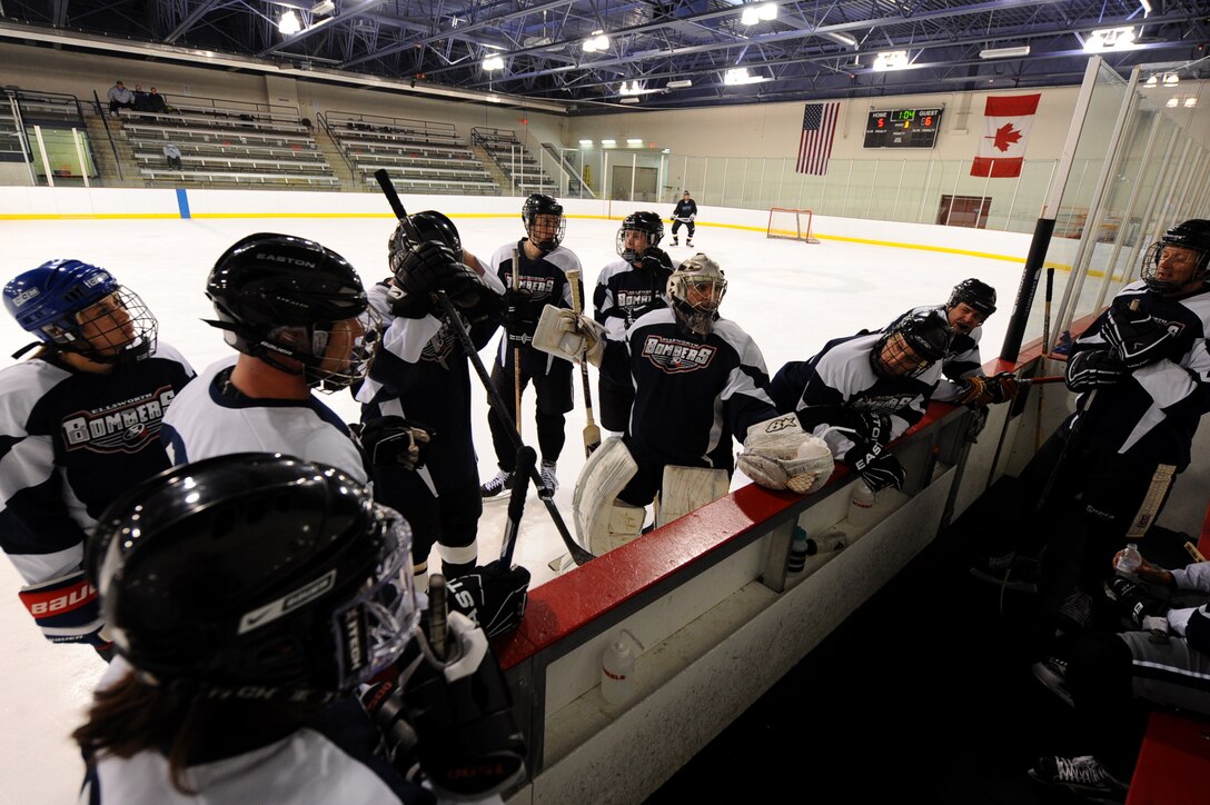 Maj. Shawn Bock (goalie), 37th Bomb Squadron assistant director of operations, encourages his Ellsworth Bombers Division C teammates before a game at the Roosevelt Ice Park Arena in Rapid City, S.D., Nov. 22, 2011. Bock is the starting goalie and manager of the two teams. (U.S. Air Force photo by Airman 1st Class Zachary Hada/Released)
