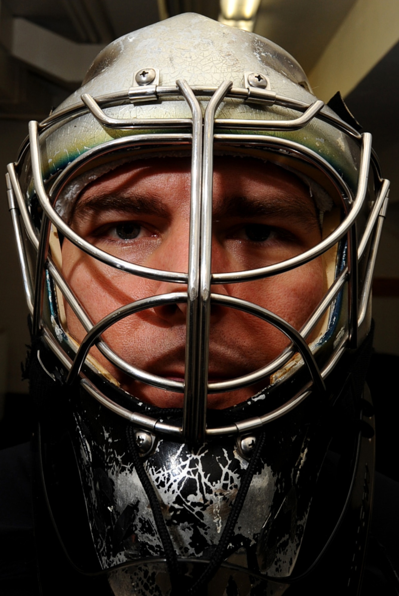 Maj. Shawn Bock, 37th Bomb Squadron assistant director of operations, suits up in the locker room before a game at the Roosevelt Ice Park Arena in Rapid City, S.D., Nov. 22, 2011. Bock is the goalie for the Ellsworth Bombers B and C division teams. (U.S. Air Force photo by Airman 1st class Zachary Hada/Released)