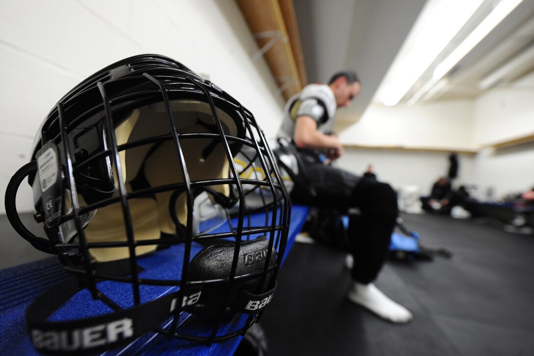 Staff Sgt. Bradley Kasch, 28th Bomb Wing public affairs broadcaster, suits up for a hockey game at the Roosevelt Ice Park Arena in Rapid City, S.D., Nov. 22, 2011. Helmets and face shields have been proven to significantly reduce the risk of head and face injuries from collisions and being struck by pucks, sticks, skates, players and falls on the ice. (U.S. Air Force photo by Airman 1st Class Zachary Hada/Released)