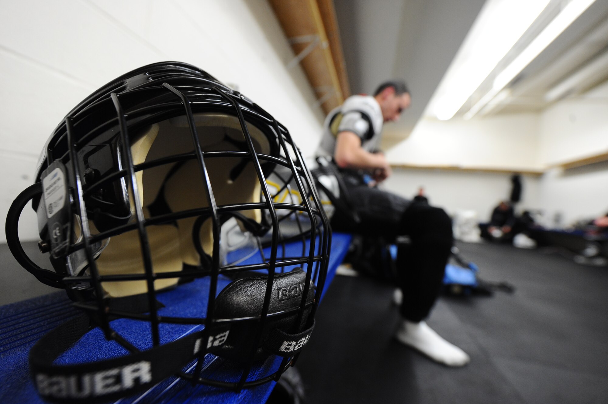 Staff Sgt. Bradley Kasch, 28th Bomb Wing public affairs broadcaster, suits up for a hockey game at the Roosevelt Ice Park Arena in Rapid City, S.D., Nov. 22, 2011. Helmets and face shields have been proven to significantly reduce the risk of head and face injuries from collisions and being struck by pucks, sticks, skates, players and falls on the ice. (U.S. Air Force photo by Airman 1st Class Zachary Hada/Released)
