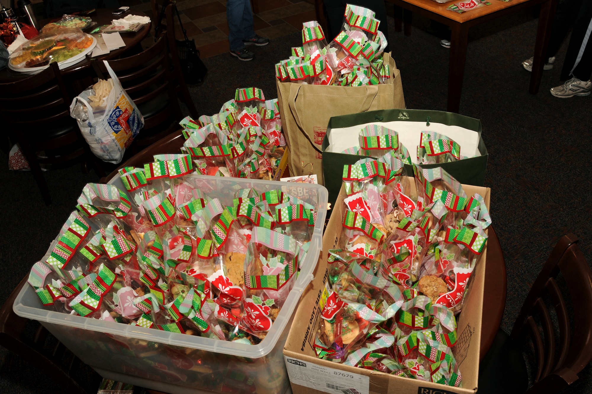 Packaged cookies are organized into different groups at the Community Activity Center on Dec. 5 at Grand Forks Air Force Base, N.D.  Every year base volunteers surprise the Airmen who live in the dorms with a taste of the upcoming holiday to boost their morale.  (US Air Force photo by Airman 1st Class Xavier Navarro)