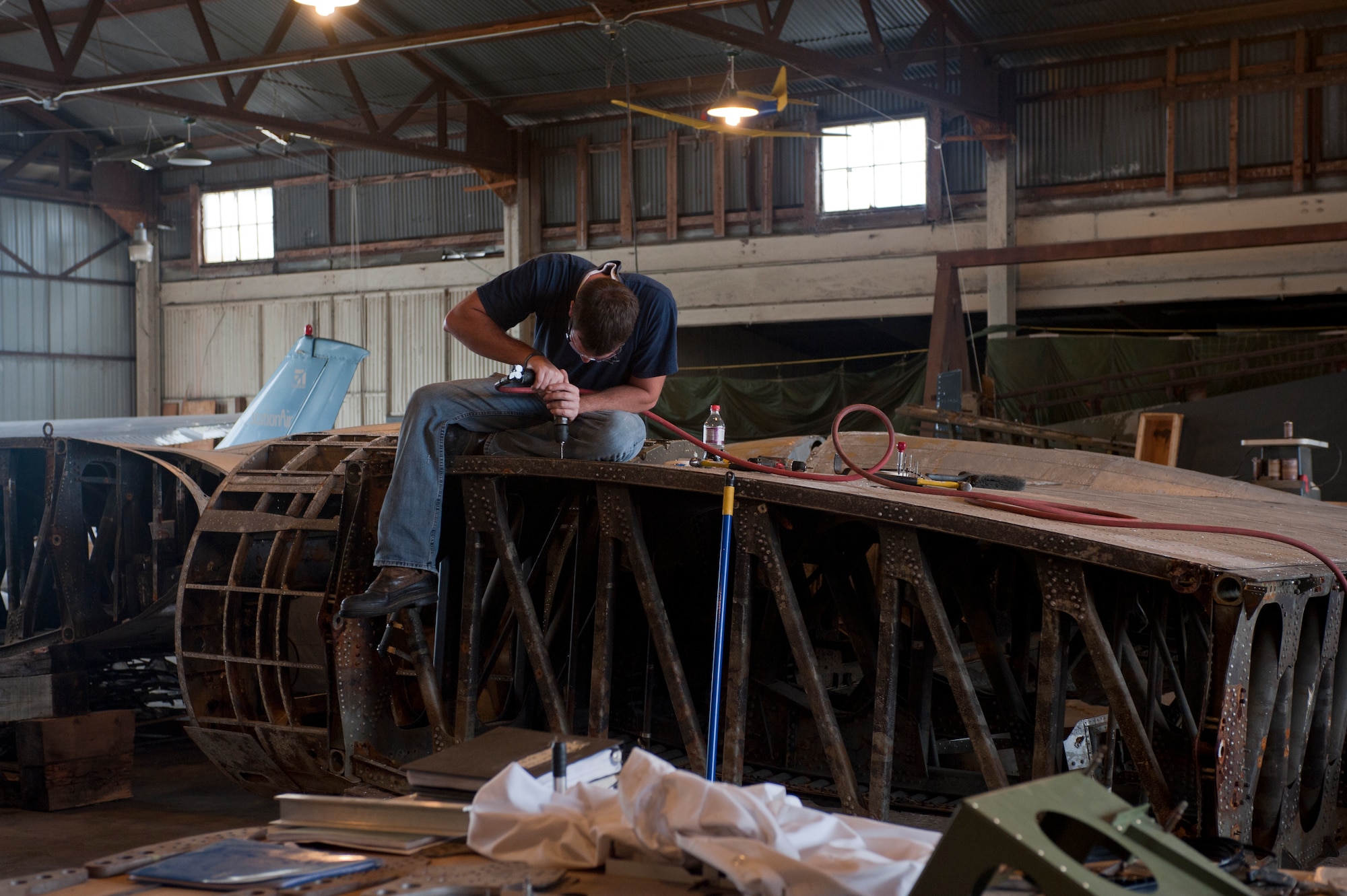 Ken Prescott, an aviation mechanic with Brooks Aviation, works on a B-17 Flying Fortress wing in a hangar in Douglas, Ga., Oct. 18, 2011. Tom Reilly, owner of the B-25 Group, has restored numerous B-17s and supervises the project for fellow aircraft restoration expert, Don Brooks. The B-17 restoration takes place in a hangar adjacent to Reilly’s. (U.S. Air Force photo by Airman 1st Class Jarrod Grammel/Released)
