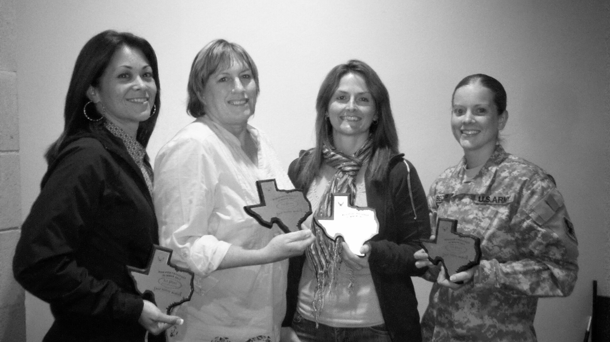 GOODFELLOW AIR FORCE BASE, Texas-- From left to right, Patty Browning, 316th Training Squadron instructor, Becky Sorrell, 316th TRS instructor, Shannon Moseley, a yoga instructor and Army Staff Sgt. Caitlin Beckles, 316th TRS instructor receive a plaque showing the greatest decrease in body fat composition, during the latest Bod Pod challenge. The eight week course challenges teams to develop healthy eating and exercise habits to promote overall health. (courtesy photo) 