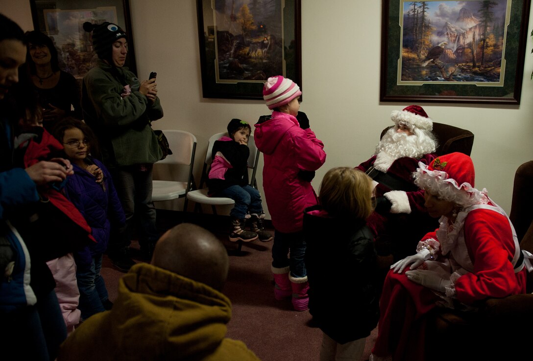Children lined up to meet Santa and Mrs. Claus to tell them what they want for Christmas during the 28th Bomb Wing Christmas Tree Lighting Ceremony at the Freedom Chapel on Ellsworth Air Force Base, S.D., Dec. 1, 2011. The chapel provided refreshments, cookies and candy canes to the children and families who attended the event. (U.S. Air Force photo by Airman 1st Class Kate Thornton/Released)